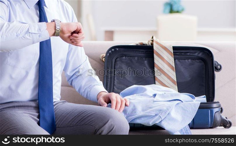 The businessman preparing packing for business trip. Businessman preparing packing for business trip