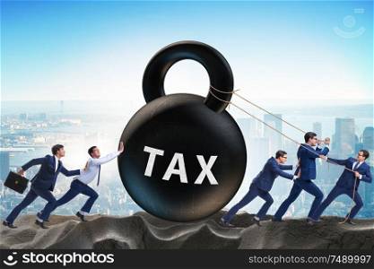The businessman pulling kettlebell in tax concept. Businessman pulling kettlebell in tax concept