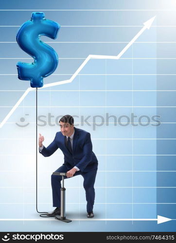 The businessman pumping dollar sign in business concept. Businessman pumping dollar sign in business concept