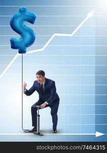 The businessman pumping dollar sign in business concept. Businessman pumping dollar sign in business concept