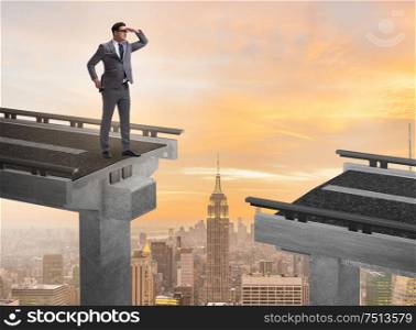 The businessman ready to overcome the broken bridge. Businessman ready to overcome the broken bridge