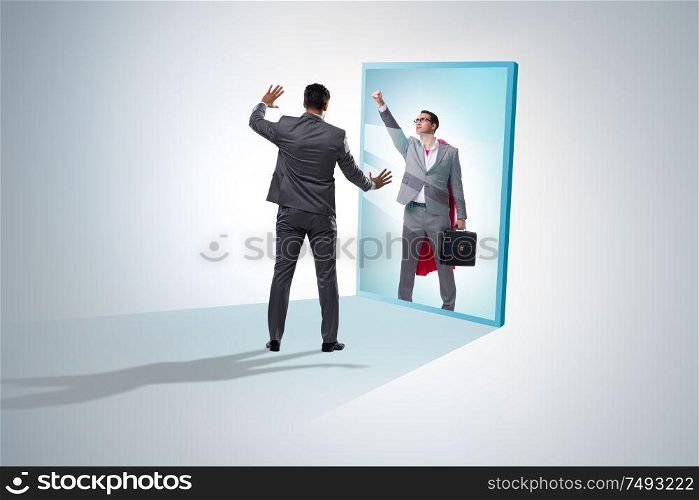 The businessman seeing himself in mirror as superhero. Businessman seeing himself in mirror as superhero