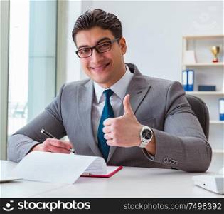 The businessman signing business documents in office. Businessman signing business documents in office