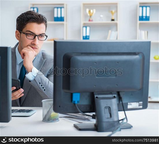 The businessman sitting in front of many screens. Businessman sitting in front of many screens