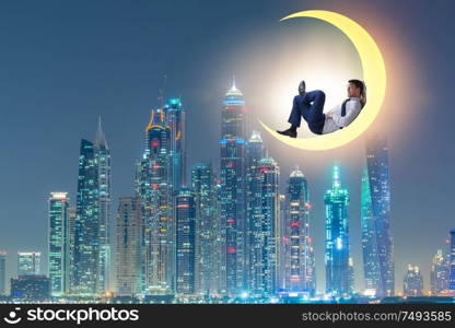 The businessman sitting on the crescent moon. Businessman sitting on the crescent moon