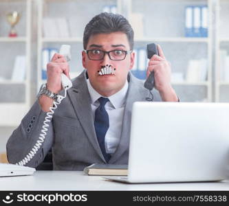 The businessman smoking in office at work. Businessman smoking in office at work