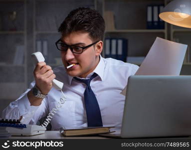 The businessman speaking on phone and smoking in office. Businessman speaking on phone and smoking in office