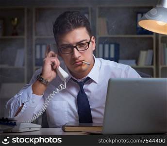 The businessman speaking on phone and smoking in office. Businessman speaking on phone and smoking in office