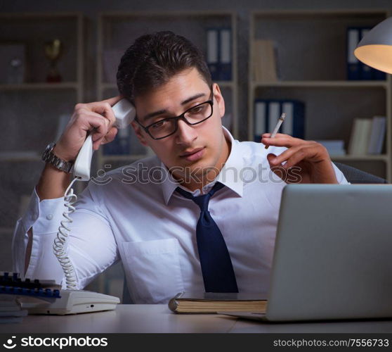 The businessman speaking on phone and smoking in office. Businessman speaking on phone and smoking in office