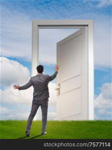 The businessman standing in front of door into future. Businessman standing in front of door into future