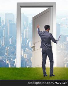 The businessman standing in front of door into future. Businessman standing in front of door into future