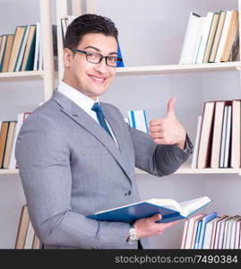 The businessman student reading a book studying in library. Businessman student reading a book studying in library