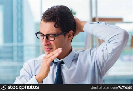 The businessman suffering from excessive armpit sweating. Businessman suffering from excessive armpit sweating