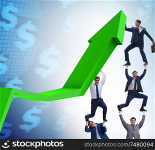 The businessman supporting growtn in economy on chart graph. Businessman supporting growtn in economy on chart graph