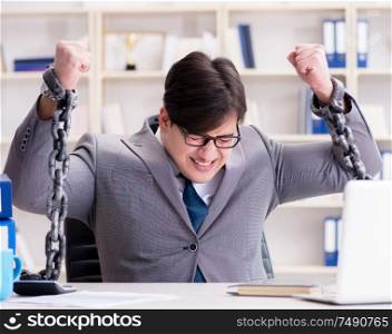 The businessman tied with chains to his work. Businessman tied with chains to his work