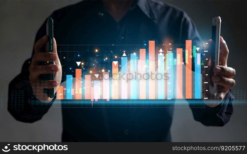 The businessman trader investor analyst uses the mobile phone app analytics to analyze cryptocurrency financial market data, trading data index charts, and graphs on a laptop and a smartphone. 