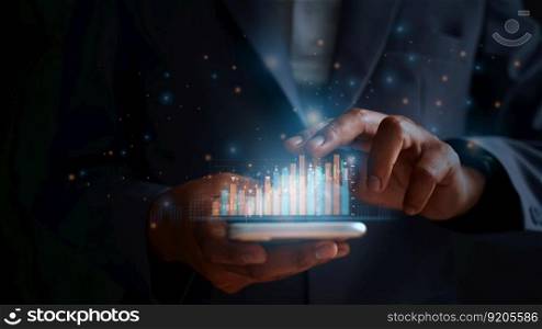 The businessman trader investor analyst uses the mobile phone app analytics to analyze cryptocurrency financial market data, trading data index charts, and graphs on a laptop and a smartphone. 
