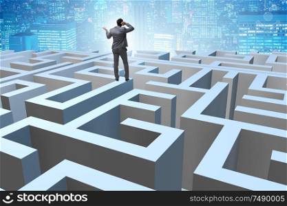 The businessman trying to escape from maze . Businessman trying to escape from maze