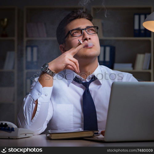 The businessman under stress smoking in office. Businessman under stress smoking in office