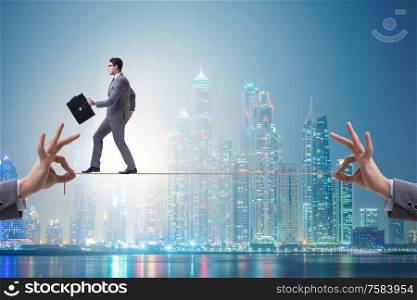 The businessman walking on tight rope. Businessman walking on tight rope