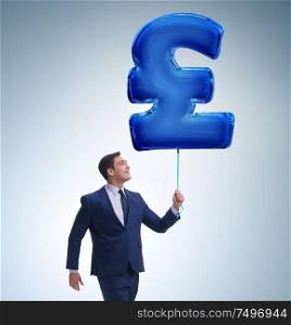 The businessman walking with inflatable british pound sign. Businessman walking with inflatable british pound sign