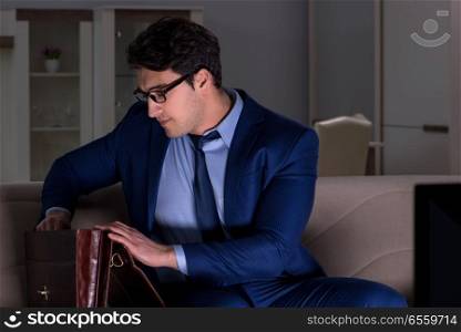 The businessman watching tv at night late. Businessman watching tv at night late