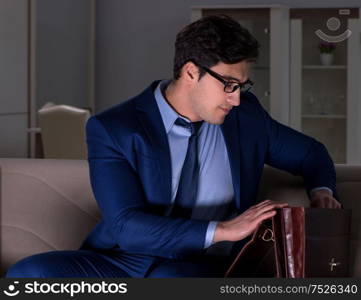 The businessman watching tv at night late. Businessman watching tv at night late