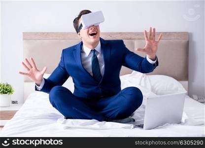 The businessman wearing a virtual reality headset in the bedroom. Businessman wearing a virtual reality headset in the bedroom