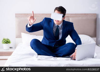 The businessman wearing a virtual reality headset in the bedroom. Businessman wearing a virtual reality headset in the bedroom