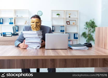 The businessman wearing mask in hypocrisy concept. Businessman wearing mask in hypocrisy concept