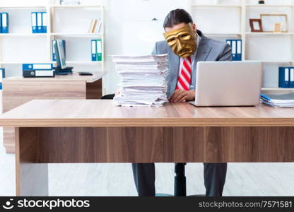 The businessman wearing mask in hypocrisy concept. Businessman wearing mask in hypocrisy concept