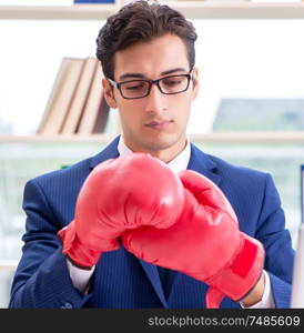 The businessman with boxing gloves angry in office. Businessman with boxing gloves angry in office