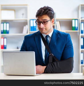 The businessman with broken arm working in office. Businessman with broken arm working in office