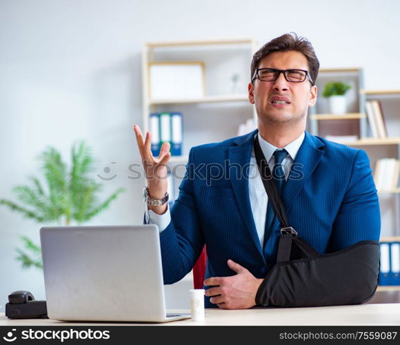 The businessman with broken arm working in office. Businessman with broken arm working in office