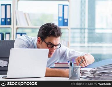 The businessman with excessive work paperwork working in office. Businessman with excessive work paperwork working in office