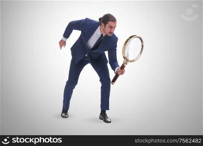 The businessman with giant magnifying glass. Businessman with giant magnifying glass