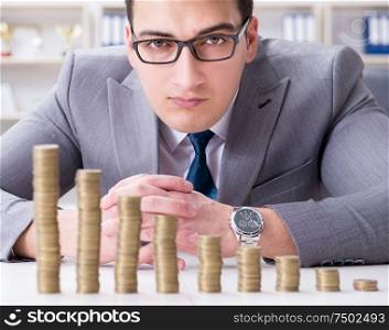 The businessman with golden coins in business growth concept. Businessman with golden coins in business growth concept