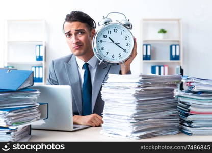 The businessman with heavy paperwork workload. Businessman with heavy paperwork workload