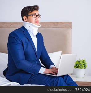 The businessman with neck injury working from home. Businessman with neck injury working from home