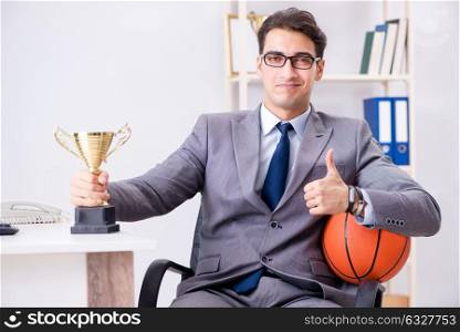 The businessman with prize cup for achievements in office. Businessman with prize cup for achievements in office