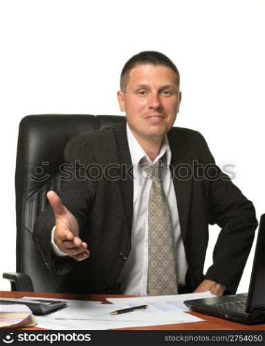 The businessman with salutatory gesture on the workplace. It is isolated on a white background