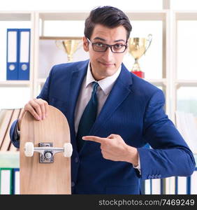 The businessman with skateboard in office. Businessman with skateboard in office