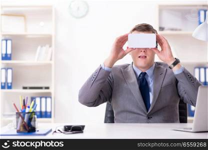 The businessman with virtual reality glasses in office. Businessman with virtual reality glasses in office
