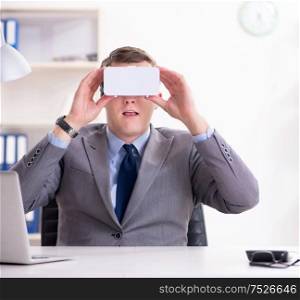The businessman with virtual reality glasses in office. Businessman with virtual reality glasses in office