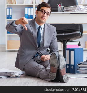 The businessman working and sitting on floor in office. Businessman working and sitting on floor in office