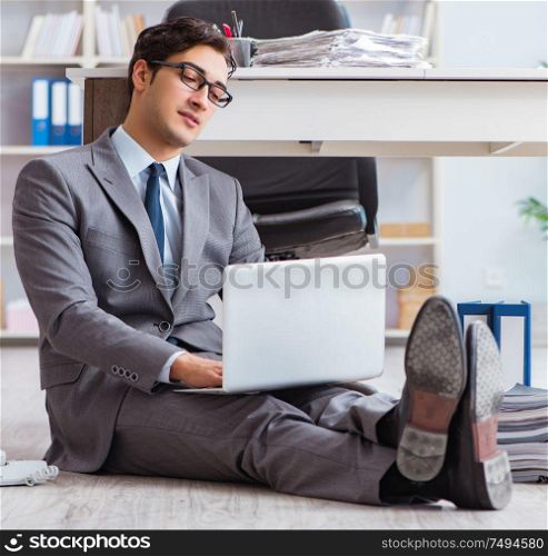 The businessman working and sitting on floor in office. Businessman working and sitting on floor in office