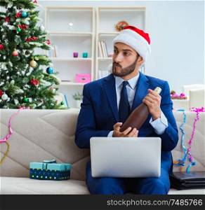 The businessman working at home during christmas. Businessman working at home during christmas