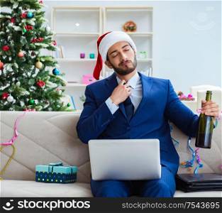 The businessman working at home during christmas. Businessman working at home during christmas