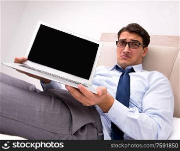 The businessman working in the bed at home. Businessman working in the bed at home