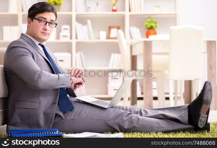 The businessman working on the floor at home. Businessman working on the floor at home